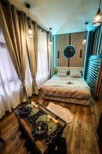 a bedroom with two beds and a table in it at O'SPA 25 - Bien Etre et Détente in Montbéliard