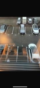 a view of a parking lot with cars and a train at Eben ezer concept in Târgu-Mureş