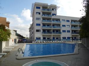 a hotel with a swimming pool in front of a building at Dream Away Alicante in Alicante