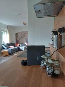 a living room with a couch and a table at Natuur Appartement Dinxperlo in Dinxperlo