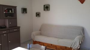 a living room with a couch and a cabinet at Appartement à la campagne in Aiglun