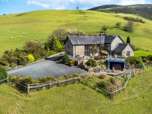an aerial view of a house in a field at 5 Bed in Garth BN162 in Garth