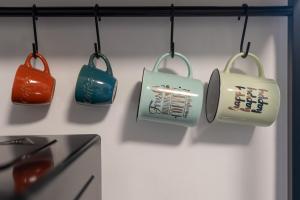 a group of kitchen utensils hanging on a wall at LOFT OLIMPICO TORINO in Turin