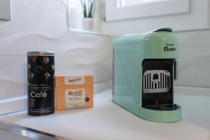 LOFT OLIMPICO TORINO في تورينو: آلة صنع القهوة وصندوق على منضدة