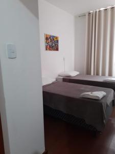 a room with two beds and a window at São Pedro in Pelotas