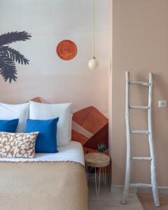 a bedroom with a bed with blue pillows and a ladder at "Le Majorelle" logement atypique en hyper centre, avec service premium by PRIMO C0NCIERGERIE in Nevers