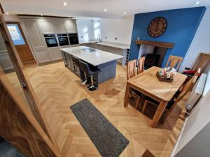 a kitchen and dining room with a table and a clock at Bryn Glo in Capel Curig