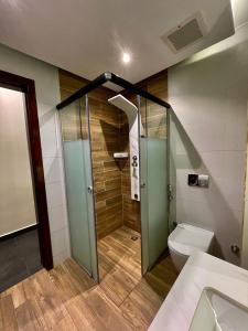 a bathroom with a shower and a toilet at fun beach durrat alarous -فن بيتش درة العروس in Durat  Alarous