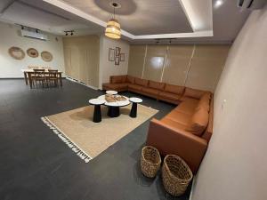a living room with a couch and a table at fun beach durrat alarous -فن بيتش درة العروس in Durat  Alarous