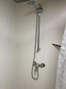 a shower in a bathroom with a shower head at Belle Vista Glamping & Camping in York