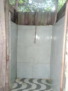 a bathroom with a shower with a tiled floor at Cabana bem - ti - vi in Camaçari