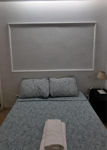 a bedroom with a bed with a large headboard at Mini Apartamento Lovely Chueca in Madrid