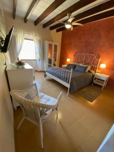 a bedroom with a bed and a table and a chair at Can Domingo in Sóller