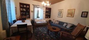 a living room with a blue couch and a table at Vasiliki's House in Mytilene