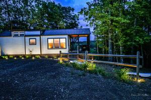 a tiny house in the woods at night at Sweet Creek Retreat in Turtletown