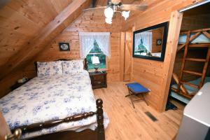 a bedroom with a bed in a wooden cabin at Simpler Times- Mineral Bluff in Mineral Bluff