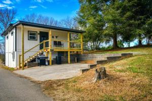 una piccola casa con portico e scala di Copper Duck Cottage a Copperhill