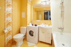 a bathroom with a toilet a sink and a washing machine at ASAO-Apartments walking center zone in Lviv +40 photos