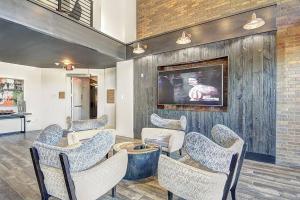 a waiting room with chairs and a wall with a tv at Lux 3BR Near Truist Park & Mall in Atlanta