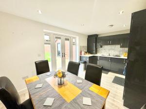 a kitchen and dining room with a table and chairs at 3 Bedroom Home centrally located in Folkestone, great location for contractors or families with parking in Folkestone