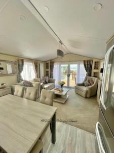 a living room with a couch and a table at Windermere View Lodge - White Cross Bay in Windermere