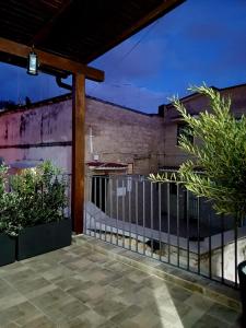 a patio with a fence and some plants at San Marco Apartment in Bari +29 photos