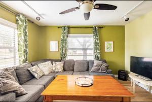 a living room with a couch and a table at 3-Bed Bungalow walk to Historic Downtown Sanford in Sanford