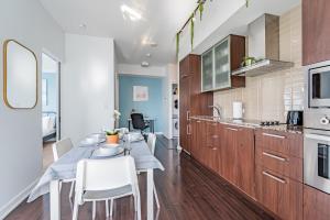 cocina y comedor con mesa y sillas en Downtown Apartments 3, en Toronto