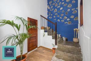 a hallway with stairs and a blue wall with a fish mural at Casablanca VV Agaete in Agaete