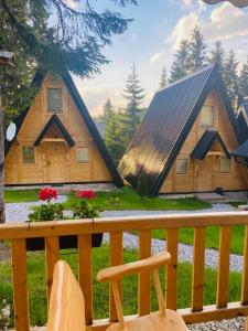 ein Holzhaus mit einem Dach auf einer Veranda in der Unterkunft ZLATARSKA IDILA in Nova Varoš