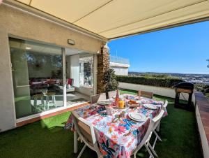 a table on a patio with a view of the ocean at The Villa Capitou in Fréjus