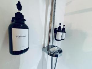 a bottle of body mist next to three other bottles at Experience Heritage, Live Modern in Upper Hutt