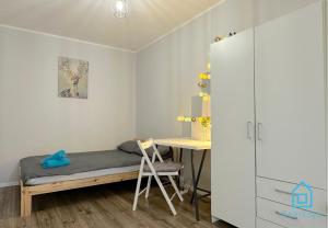 a small bedroom with a bed and a desk at Spacious Room in Gdańsk