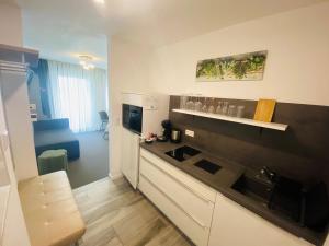 a kitchen with a sink and a counter top at Apartments Amtzell, kontaktloser Check-in in Amtzell