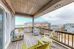 a balcony with chairs and a view of the ocean at Carried Away #16-IC in Avon