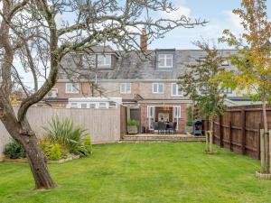 a home with a fence and a yard at 2 Bed in Isle of Purbeck DC118 in Arne