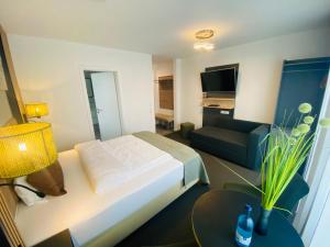 a hotel room with a bed and a couch at Apartments Amtzell, kontaktloser Check-in in Amtzell