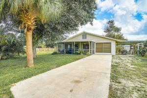 a house with a palm tree and a driveway at Newly Remodeled Home Less Than 2 Mi to Punta Gorda Airport in Punta Gorda