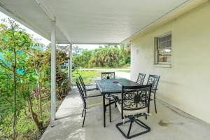 a table and chairs on the porch of a house at Newly Remodeled Home Less Than 2 Mi to Punta Gorda Airport in Punta Gorda