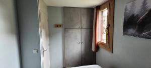 a bedroom with a cabinet and a window at Résidence Plagne Lauze - maeva Home - Appartement 2 Pièces 5 Personnes - Prestige MAE-4334 in Mâcot La Plagne +33 photos