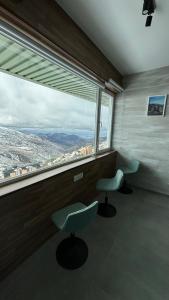 a room with two chairs and a large window at Biznaga Nevada in Granada