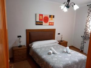 a bedroom with a bed with two pillows on it at Apartamento los rosales in Letur