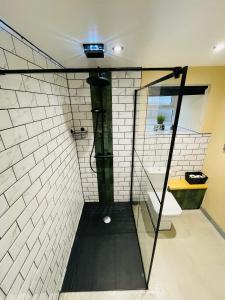 a bathroom with a glass shower with a toilet at Barnaby’s Barn in Carmarthen +16 photos