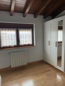 an empty room with white walls and windows at Villa San Miguel in Cudón