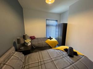 a bedroom with two beds and a window at Brand new refurb 8 person house in Hull