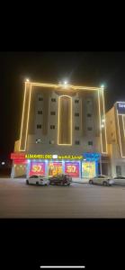 a building with two cars parked in front of it at شقق نجوم الجزيرة للشقق المخدومة in Tabuk