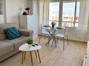 a living room with a couch and a table at VER855 - Playa y Centrico, Wifi, Fire Stick, Vistas al mar in Torremolinos