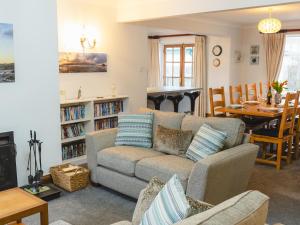 a living room with a couch and a dining room at Armstrong Cottages No30 in Bamburgh
