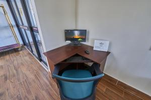 a desk with a computer on top of it at The Mariner Resort Cape Cod by The Red Collection in West Yarmouth