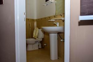 a bathroom with a sink and a toilet at The Royal Sea Clifton in Karachi